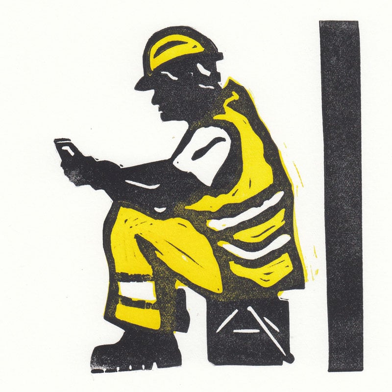 Silhouetted seated workman dressed in hi-viz yellow